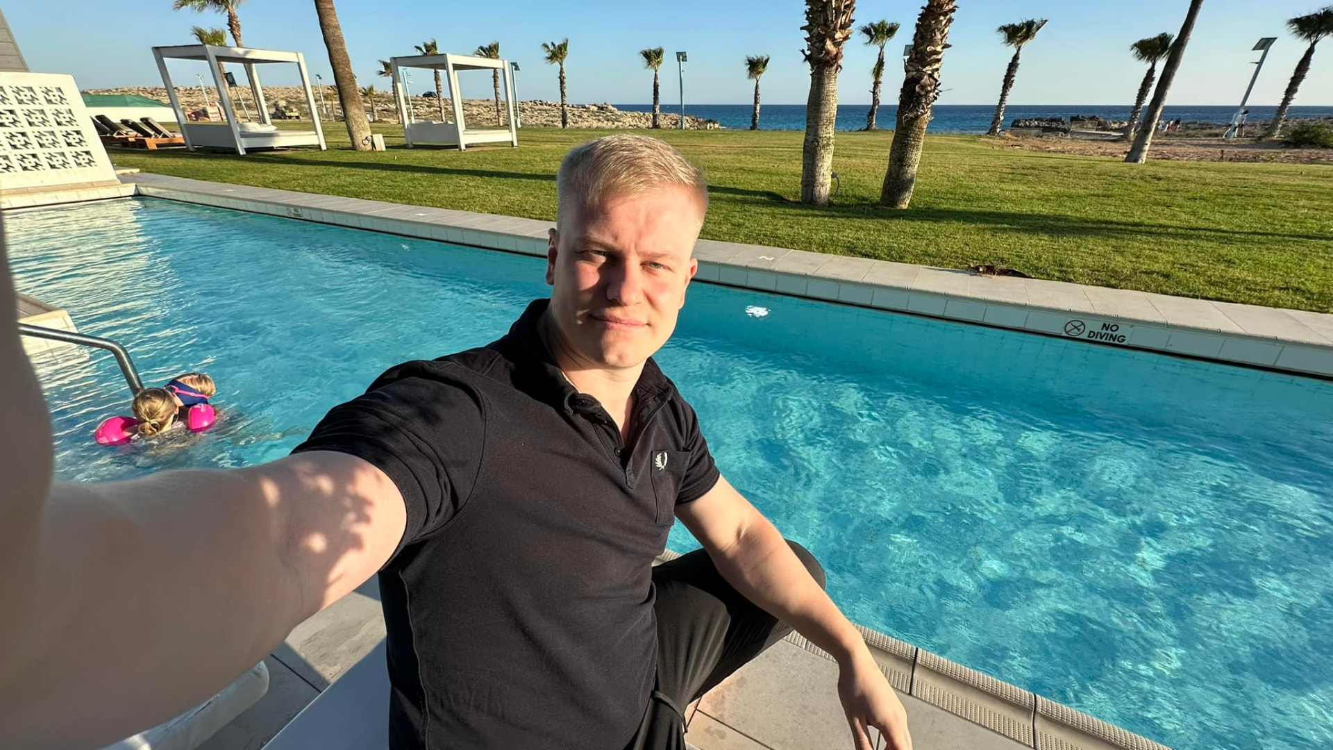 Gusten Sun beside a seaside pool