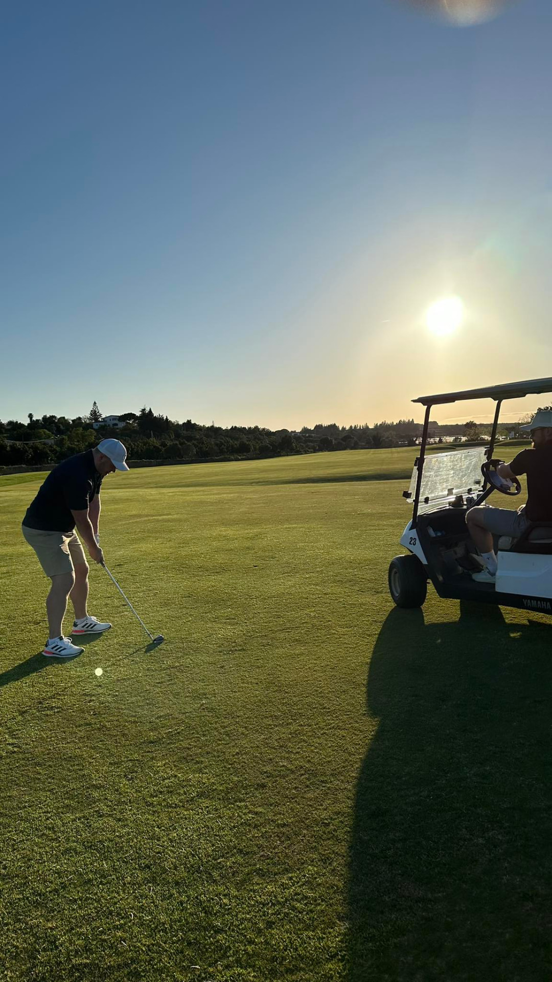 Gusten Sun playing golf at sunset